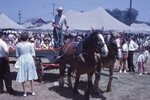 Children Ride in Wagon on Festival Grounds by Richard Hoffman