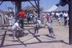 Children Play on Horse Mill on Festival Grounds by Richard Hoffman