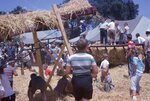 Children Play in Straw on Festival Grounds by Richard Hoffman