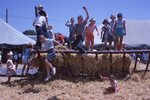 Children Play on Wagon Frame on Festival Grounds by Richard Hoffman