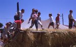 Children Play on Wagon Frame on Festival Grounds by Richard Hoffman