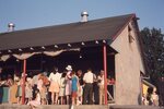 Festival Attendees Gather at Craft Stalls by Richard Hoffman