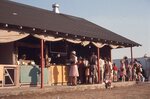 Festival Attendees Gather at Craft Stalls by Richard Hoffman