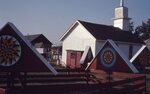 Hex Signs, Wagon, and Church Displays on Festival Grounds by Richard Hoffman
