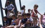 Children Playing on Giant Chair by Richard Hoffman