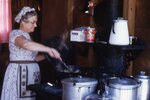 Woman Cooks on Cast Iron Stove by Richard Hoffman
