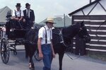 Men Driving Antique Hearse by Richard Hoffman