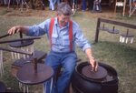 Man Dips Candles on Festival Grounds by Richard Hoffman