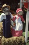 Decorative Farmer and Wife Dolls on Festival Grounds by Richard Hoffman