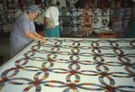 Woman Hand-Stitches Quilt in Quilt Barn by Richard Hoffman
