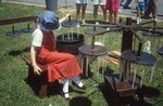 Girl Hand-Dips Candles on Festival Grounds by Richard Hoffman