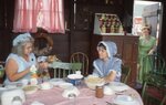 Women Sit Around Farmhouse Table by Richard Hoffman