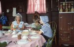 Women Sit Around Farmhouse Table by Richard Hoffman