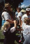 Children Pet Snake on Festival Grounds by Richard Hoffman