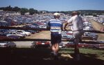 Men Overlooking Cars in Festival Lot by Richard Hoffman