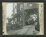 Dumping Whole Cars of Coal into Hopper to be Poured into Vessel's Hold, Conneaut, Ohio. by Keystone View Company
